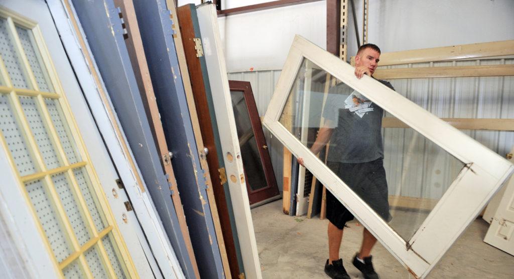 SHAW AIR FORCE BASE, S.C. -- Senior Airman Jason Albrecht, 20th Security Forces military working dog handler, organizes donated doors at the Sumter Habitat for Humanity ReStore, July 27. Proceeds from ReStore sales go into the Sumter Habitat for Humanity building fund. Habitat for Humanity is a non-profit organization that utilizes volunteer labor and donations of money and materials to eliminate poverty housing and homelessness. (U.S. Air Force photo/Senior Airman Kathrine McDowell)