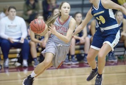 Klaire Varney dribbling down the court while being pressured by the opposing team, Emory & Henry. // PHOTO THE DAILY TIMES