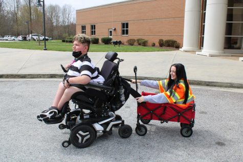 Caden Nelms pulling Emma Marti in an Academy Sports and Outdoors wagon to test the safety for other students. #AcademySponsor PHOTO // MELISSA TINGLE