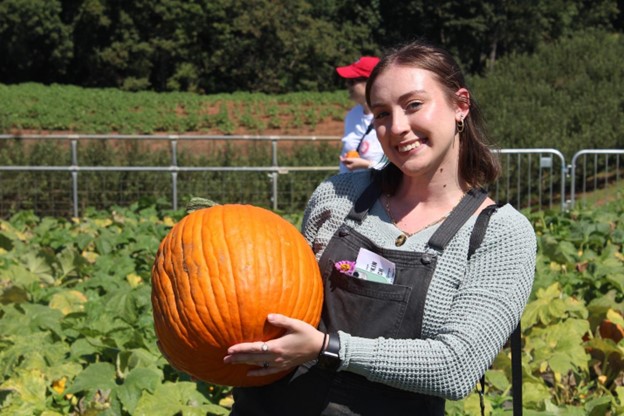 Senior graphic design major, Samantha Carvallo poses in the pumpkin patch at Jaemor // PHOTO EMMA MARTI
