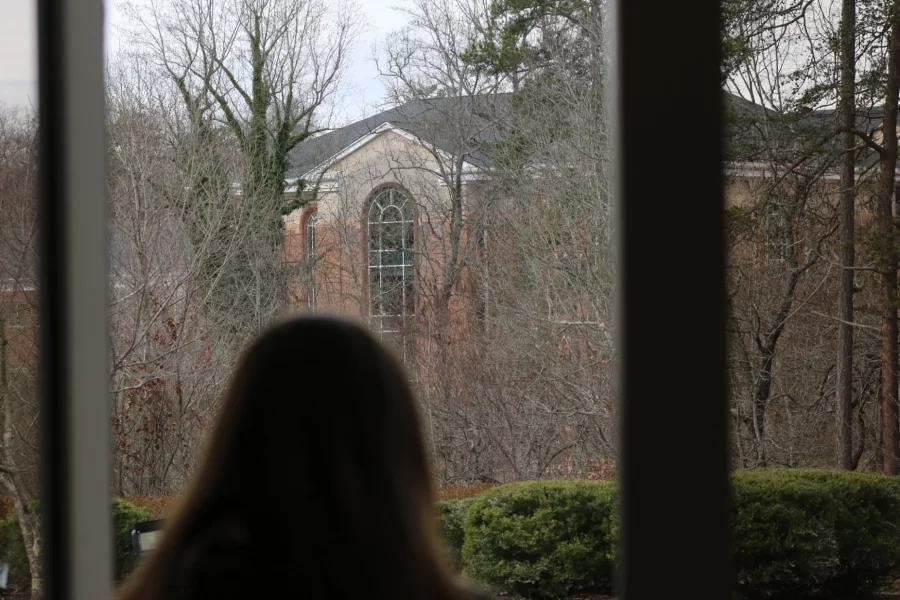 A student glances out the 3rd-floor window of Stewart Hall. PHOTO//Aaron Palmer