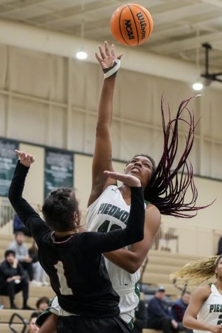 Nakiyah Washington jumping to win the ball. PHOTO// piedmont.canto.com