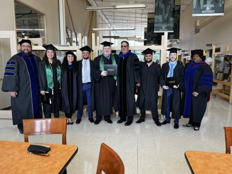 Members of the Mass Communications faculty during much happier times at the May 2022 graduation.