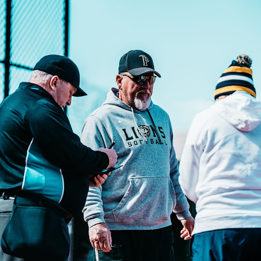 Coach Martin (middle) talking to the visitor coach and umpire before their season opener starts.
