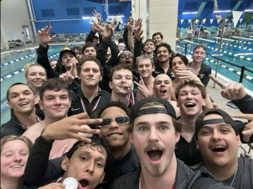 
Men’s and women’s swim pose after both teams are crowned conference champions.
