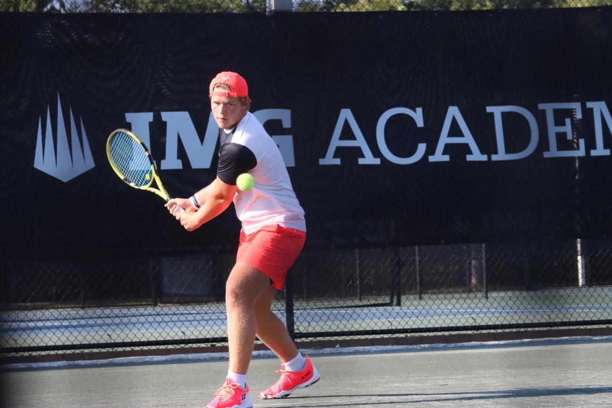 Simon Johnstone winds up to hit the tennis ball during a match at IMG Academy.