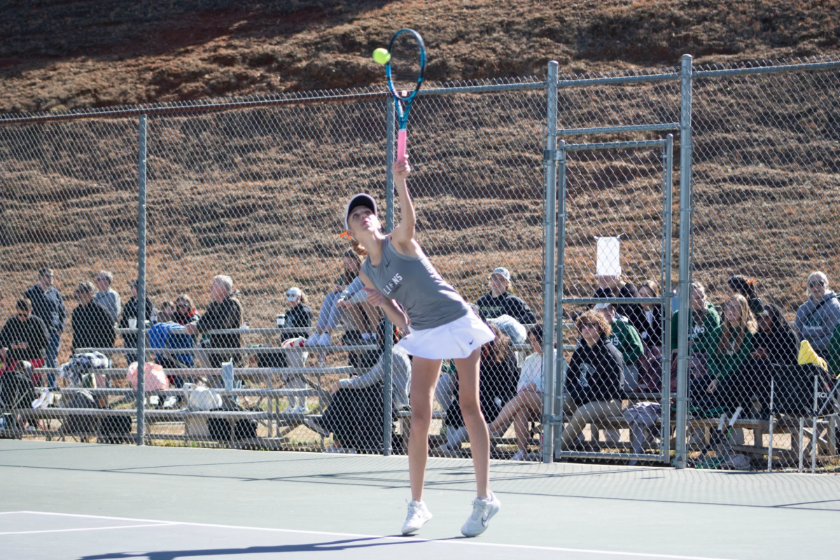 Senior Dannie Evans makes a serve against Methodist. Evans was one of four seniors who made her mark on the conference champion women's tennis team.