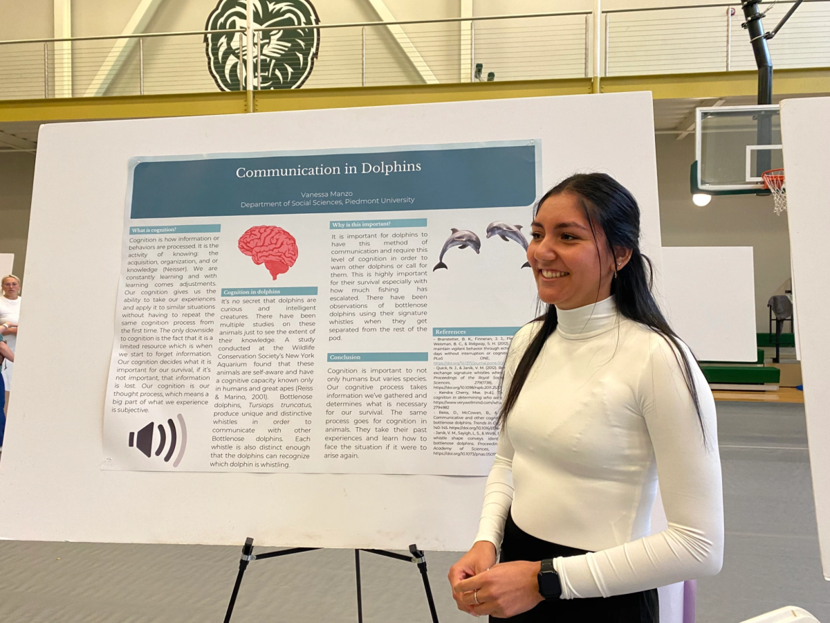 Psychology major Vanessa Manzo presents her symposium research project about cognitive communication in dolphins. Manzo was inspired to research how dolphins communicate due to her love for the sea animal.