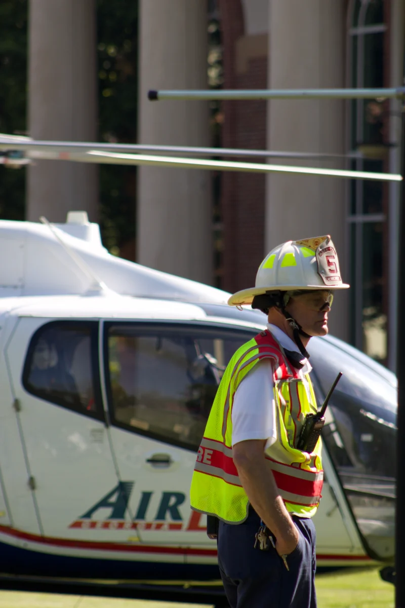 A firefighter alerts nursing students the helicopter is ready to be loaded.