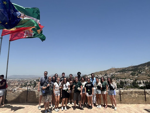 A photo of Piedmont students and professors posing in front of an Italian cityscape.