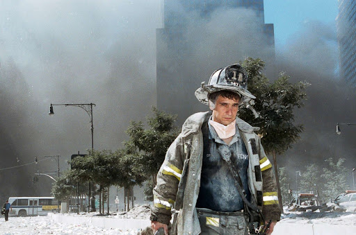 Firefighter covered in debris due to the collapse of the twin towers.