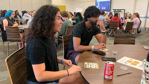 Natalie Edith Gonzalez and Maheer Mushfiq playing an intense game of Grocery Bingo.