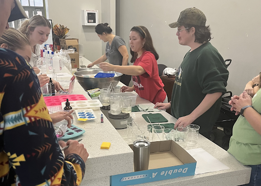 Students and visitors making soap in Student Commons.