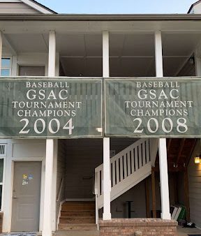 Baseball Tournament Championship Posters hanging on the railings at the village in 2023.