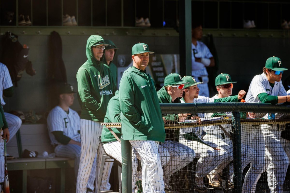 Coach Justin Scali checks out the action from in front of the dugout. The longtime Piedmont baseball coach enters the 2024 season with a 158-106-1 record.