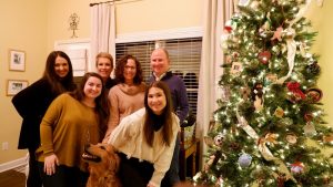 Donovan's gathering around their family tree during Christmas 2020 with sentimental ornaments on display.