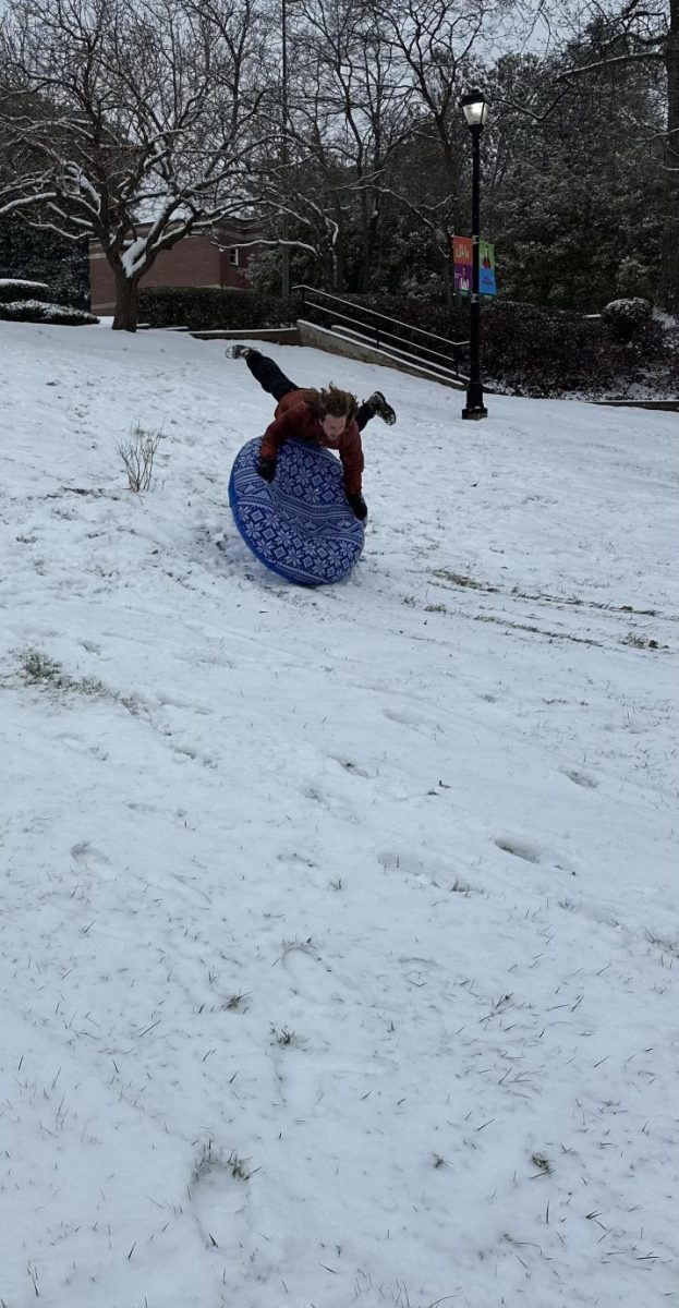 Senior Tucker Cox picks up speed going down the hill located in Piedmont's quad.