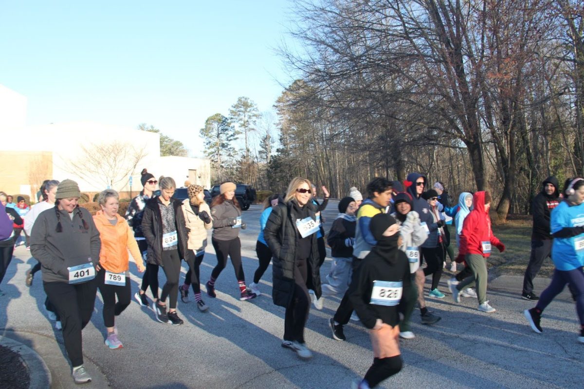 Runners jogging during the Piedmont Goes Red 5k to raise awareness for the nursing department at Piedmont University.