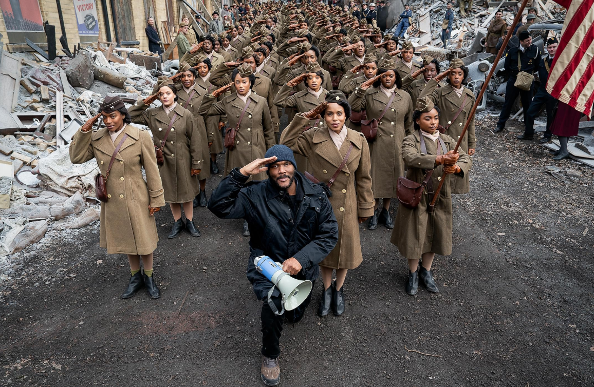 Tyler Perry and the cast of The Six Triple Eight posing by saluting.