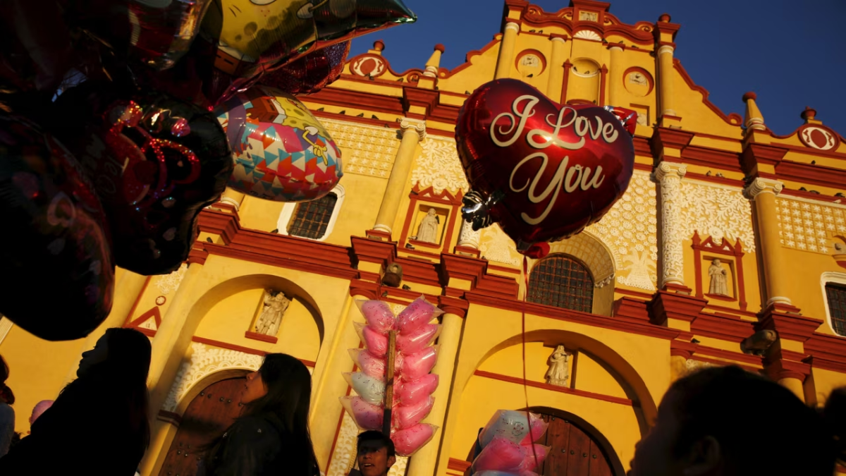 A girl looks at balloons in front of the Cathedral during Valentine's Day in San Cristobal de Las Casas, Mexico Feb. 14, 2016.