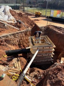 The construction team works to form the drop collection inlet that will collect all the water from around the Mize. (Austin Hicks)