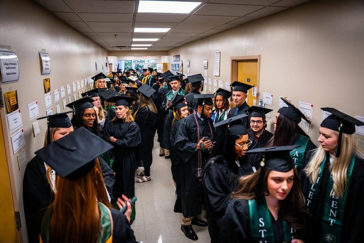 Piedmont’s 2024 fall graduates line the halls of the Johnny Mize Athletic Center, anxiously awaiting the moment they finally walk across the stage. (@PiedmontUniversity on Facebook )