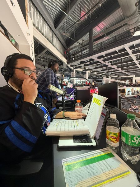 Joe Dennis reading off public address announcements at Akins Ford Arena during a Rock Lobster game.