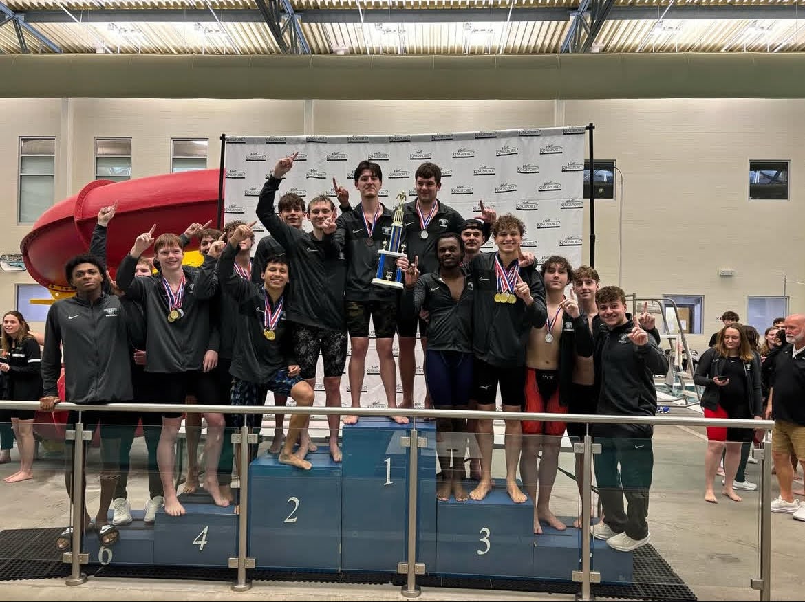 Senior Kyle Rutberg holding the Independent South Conference trophy, along with the rest of the men’s swim team. (@piedmontswim on Instagram)