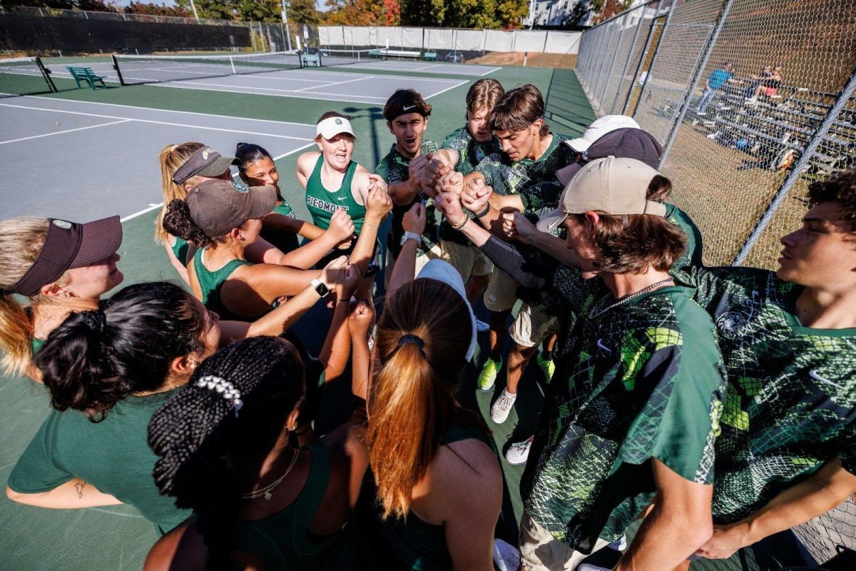 The Green team chanting before their Green vs White scrimmage. (Mooreshots)