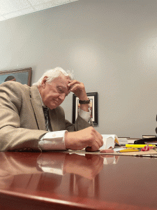Dr. Pleysier reading in his office.