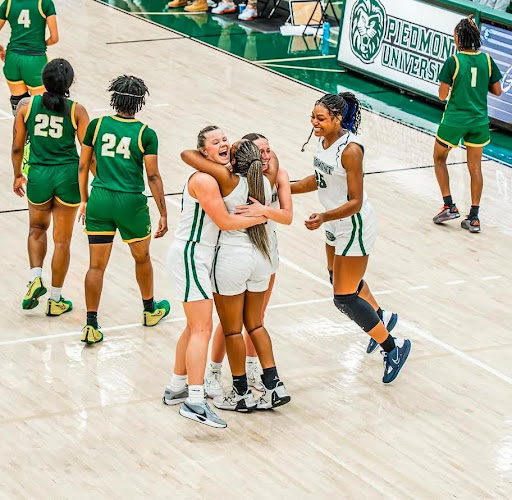 Nae-Nae Eades embracing Kennedi Henson and Ashley Scott after their CCS Conference Championship win, with Alexandra Willis joining in.