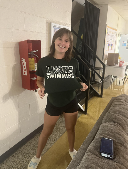 Junior Kelly Mashburn repping her Lions swim merch after practice. She set multiple program records last year, and looks to continue the trend for the 2025-26 season.