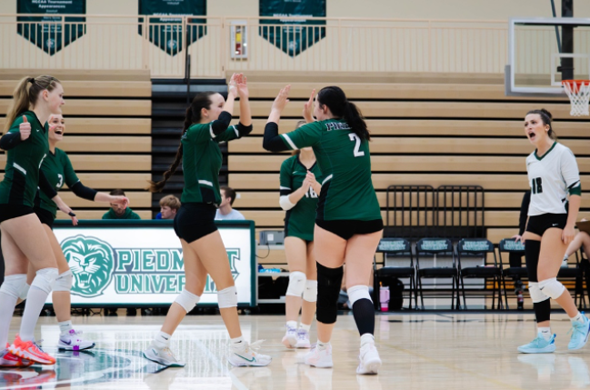  Volleyball seniors Katie Hubbard (right) and Alex Wingate (left) celebrate on the court after scoring. Hubbard currently leads the Lions in kills, with 80.