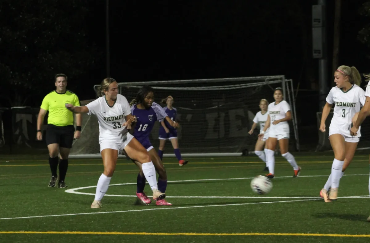 Senior Sierra Judson kicks the ball over to freshman Keira Ferrera, moving the ball into scoring territory. The Lady Lions open tournament play hosting LaGrange College on Saturday at the WAC.