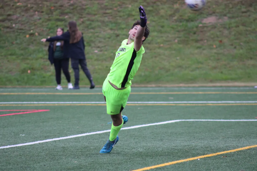 Goalkeeper Collin Sheeler leaps to defend the net during a close play against the Johnson & Wales Wildcats.
