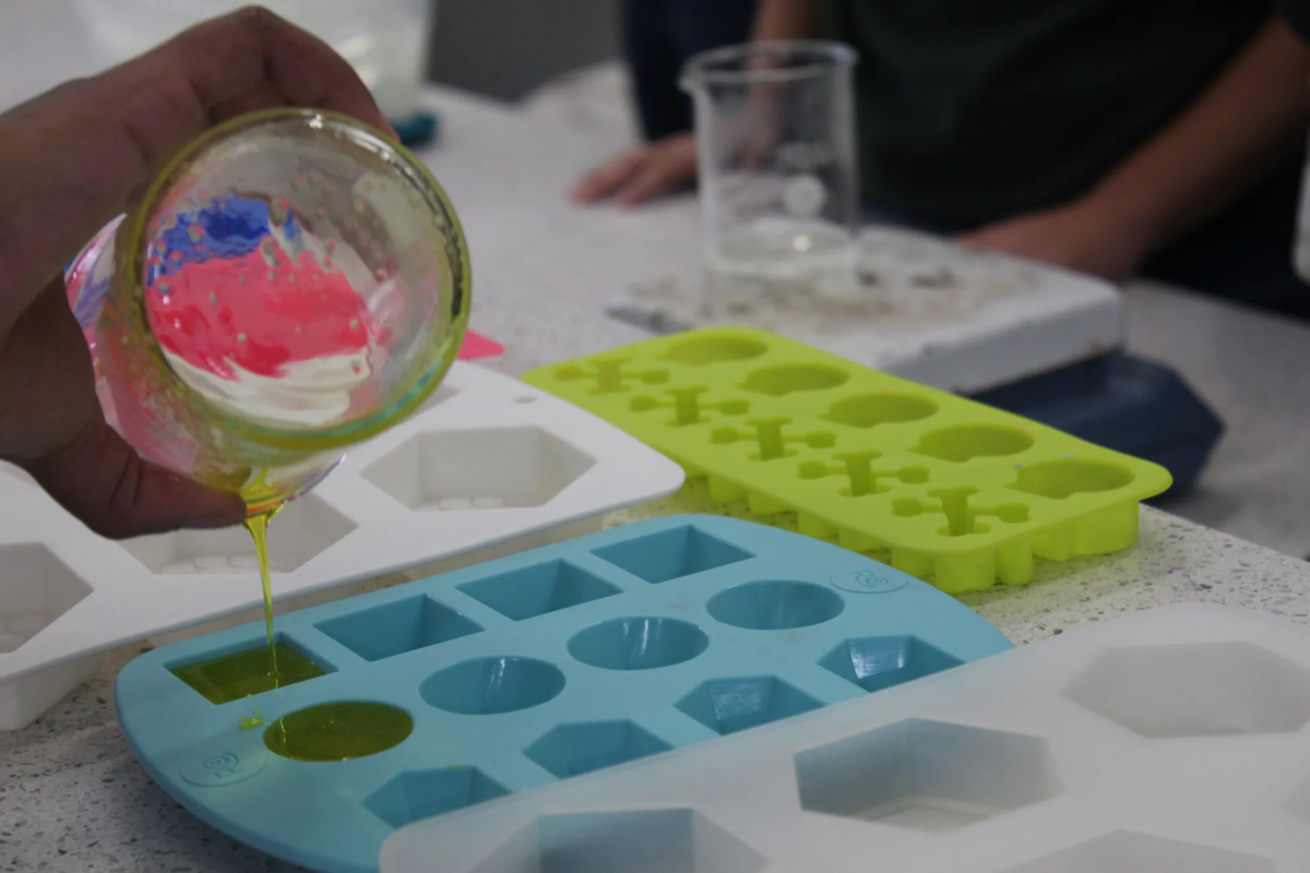 A Piedmont student pours their soap mixture into the mold of their choice as they made it their own on Global Hand Washing Day.