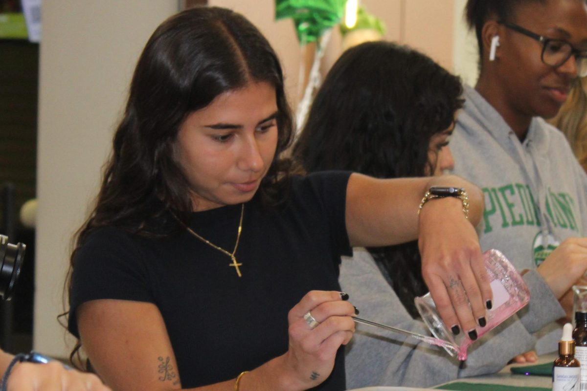 Piedmont student Christina Sierra pours her soap mixture into a mold while taking part in a soap-making activity held for Global Handwashing Day in the Student Commons on Oct. 24.