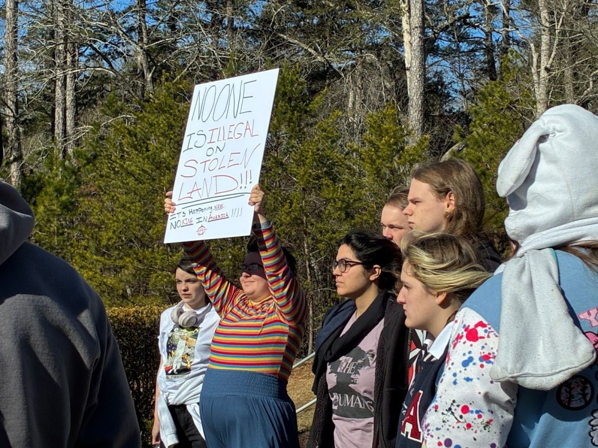 Students raise their voices and signs during a peaceful campus protest opposing ICE actions as a part of a nationwide walkout.