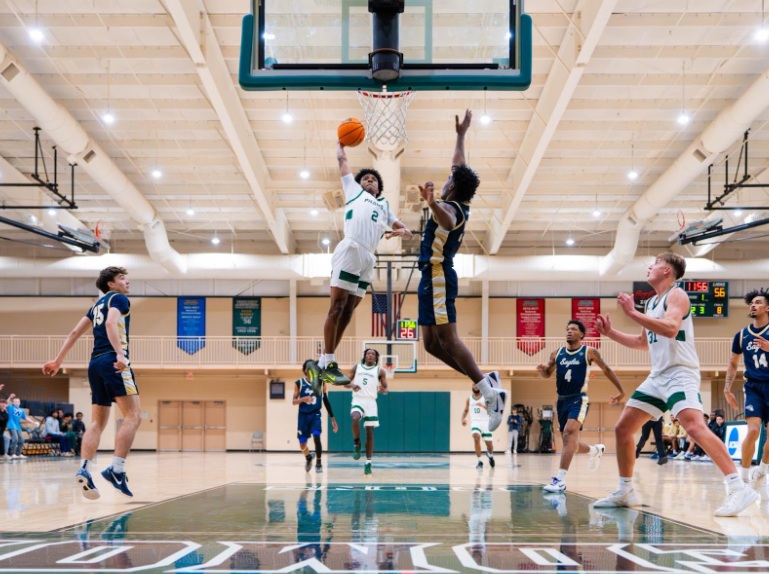 Junior guard Israel Hall soaring to the rim during a win against Buffalo University of Florida. Hall contributed 14 points to a Lions victory.